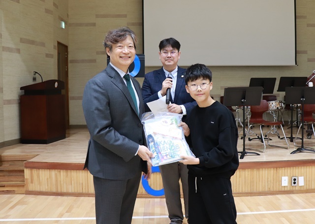 구강건강 O/X 퀴즈에서 1등을 차지한 학생에게 경치 전성원 회장이 상품을 전달하고 있다.